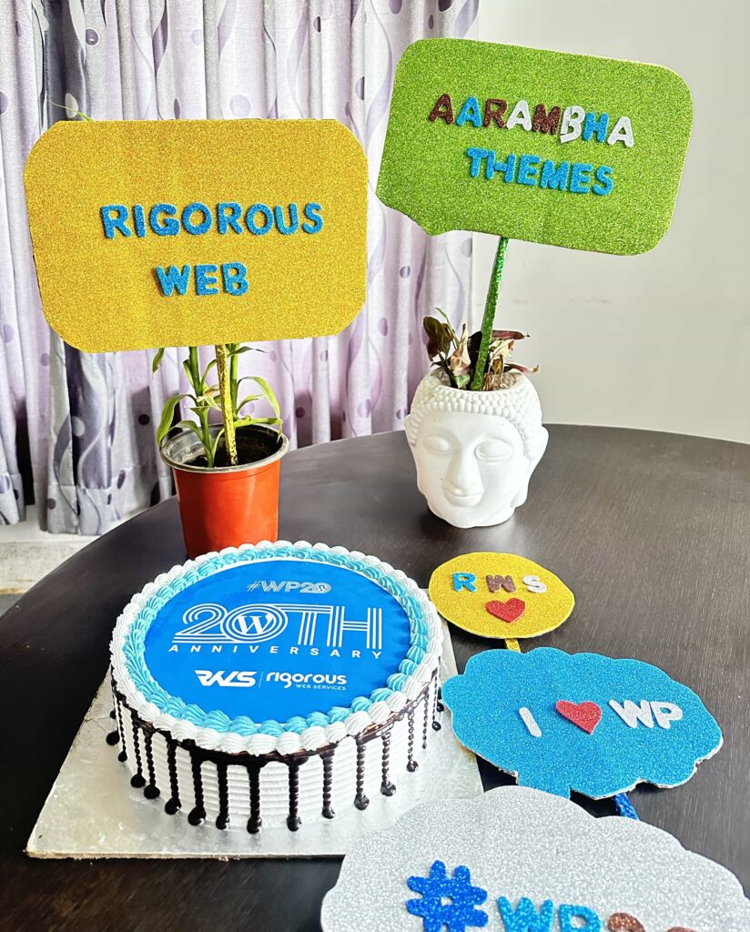 20th WordPress Anniversary cake and props of Rigorous Web and Aarambha Themes